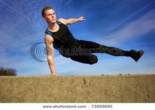stock-photo-young-man-jumping-over-wall-on-obstacle-course-73669690